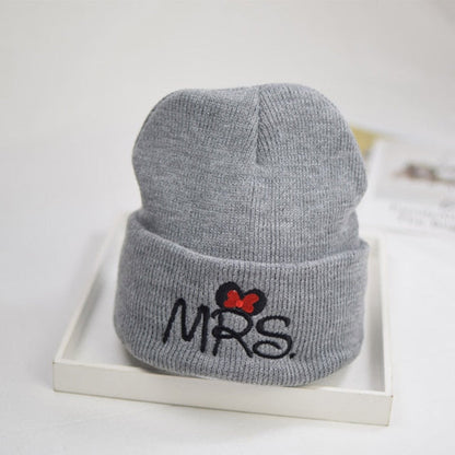 Smiling baby wearing a comfortable white knit toddler hat, soft cotton for delicate skin.