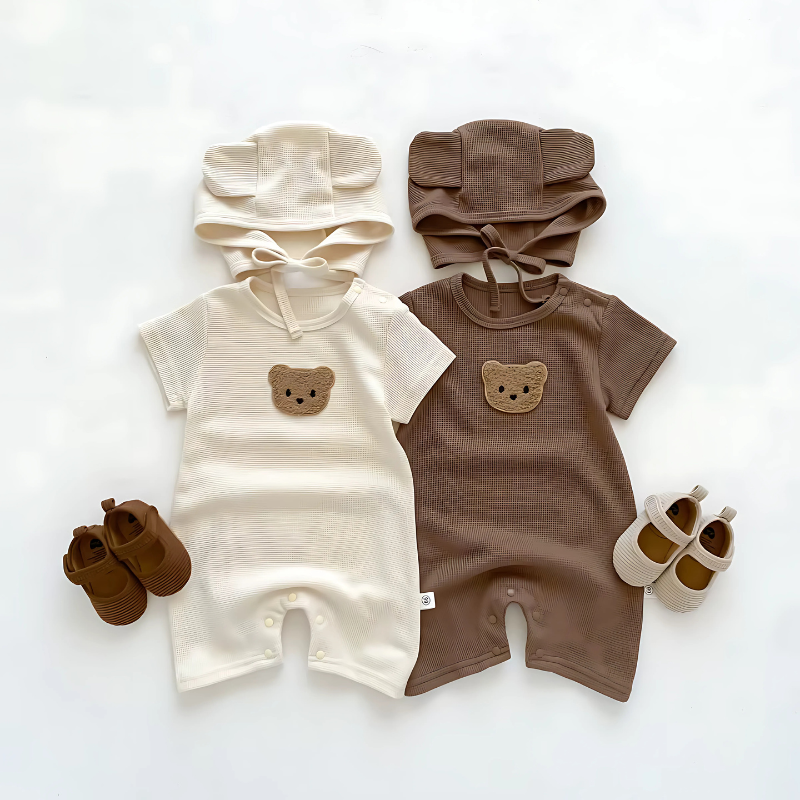 Adorable baby in a soft cotton bear romper and matching hat, perfect for newborns or baby gifts.
