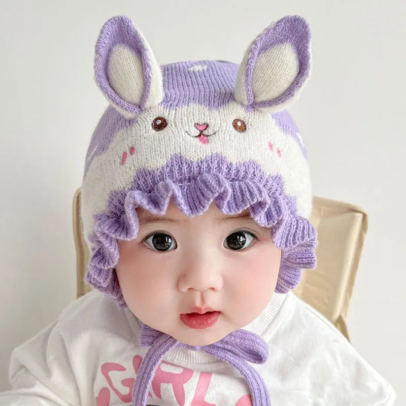 Close-up of the textured fabric of a baby rabbit winter hat, emphasizing its softness.