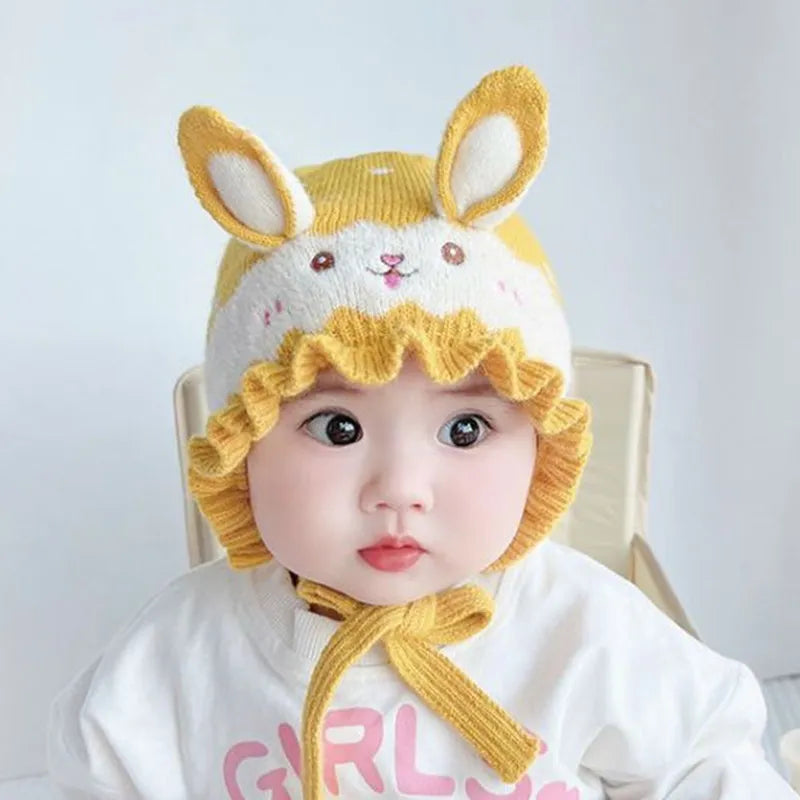 Toddler playing outdoors, wearing a warm rabbit winter hat, essential baby winter hat.