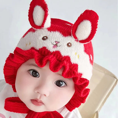 Closeup of a cute toddler wearing a unisex baby rabbit winter hat with long ears and cozy fabric.