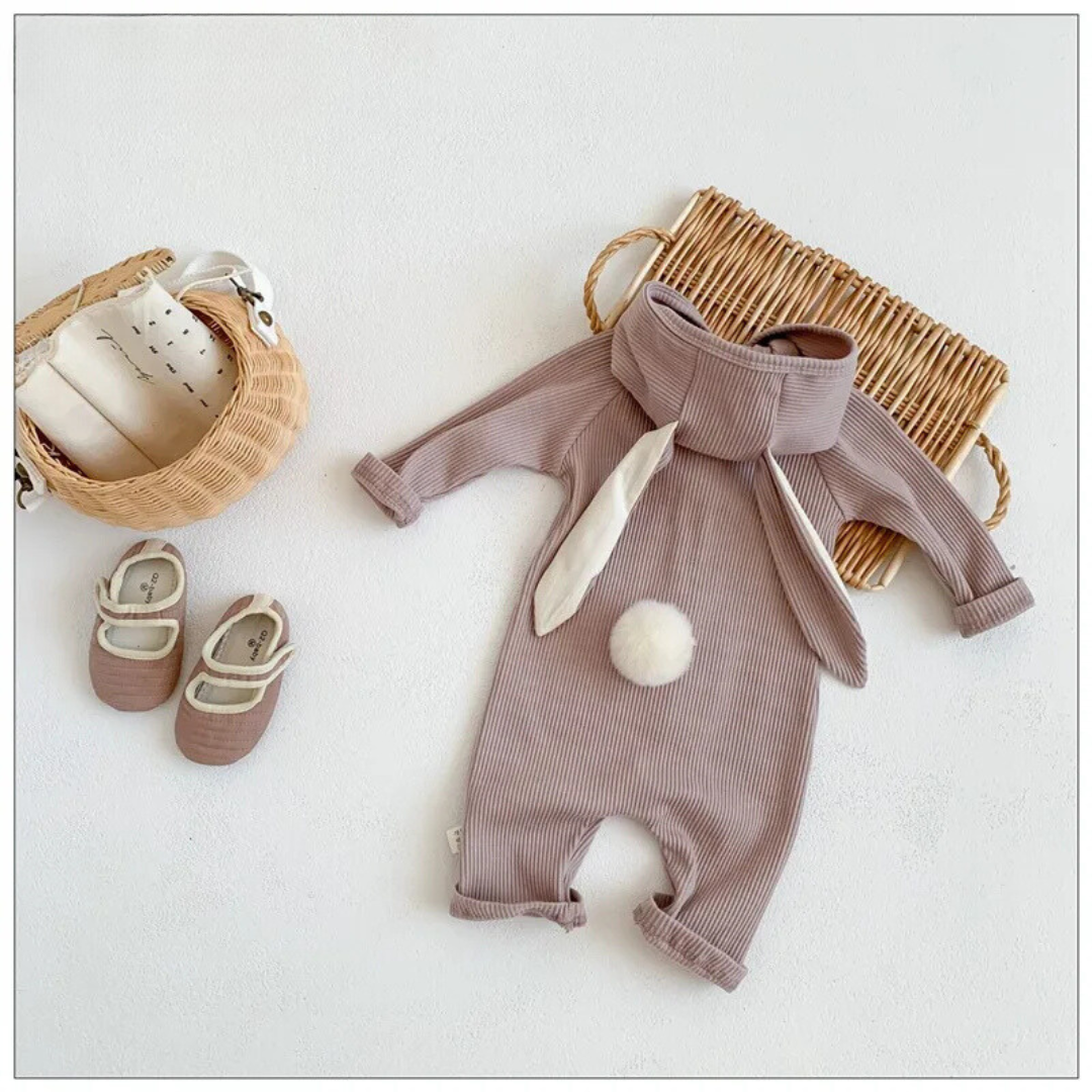 Adorable baby in a unisex white cotton rabbit design romper, perfect for infants and toddlers.