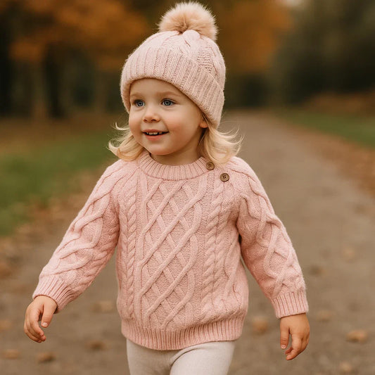 Adorable baby in a warm knitted wool winter sweater, cozy and perfect for cold weather