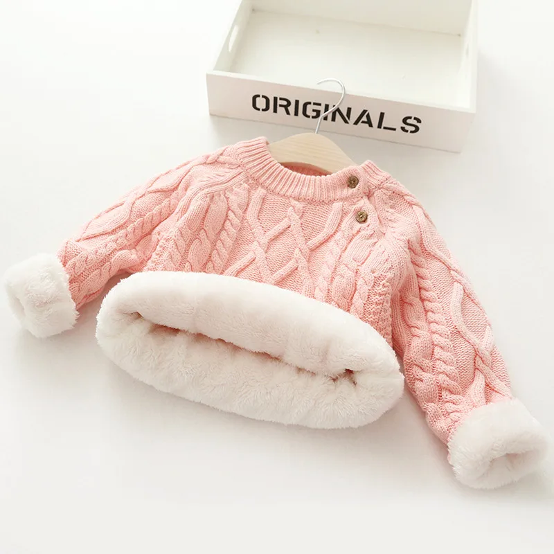 Folded baby & toddler knitted wool winter sweater, highlighting its compact and soft nature