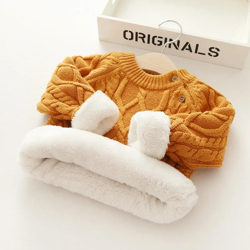 Close-up of the knit pattern on a toddler's winter sweater, showing the quality wool blend yarn