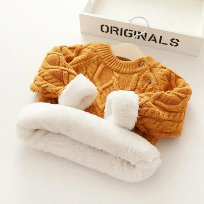 Close-up of the knit pattern on a toddler's winter sweater, showing the quality wool blend yarn