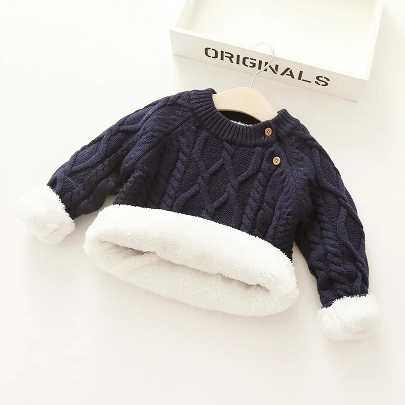 Stylish baby wearing a comfortable and warm wool blend winter sweater, ready for outdoor play