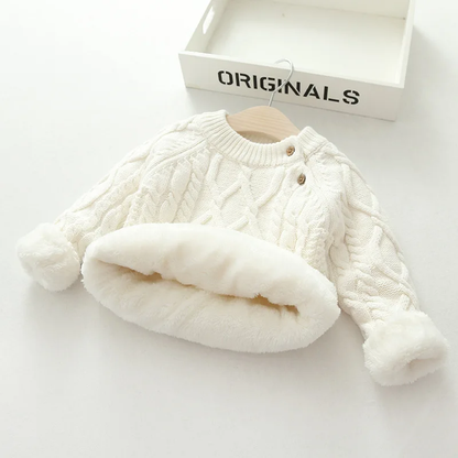 Side view of a toddler in a cozy o-neck knitted sweater, suitable for chilly days