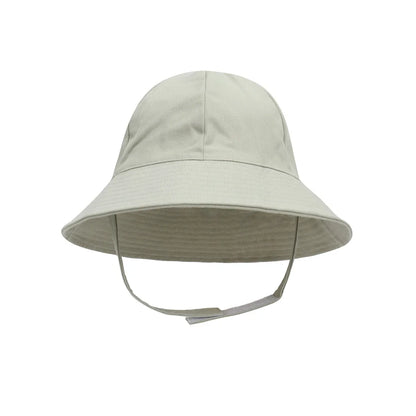 Overhead shot of a baby wearing an adjustable sun protection bucket hat, keeping cool on sunny day.