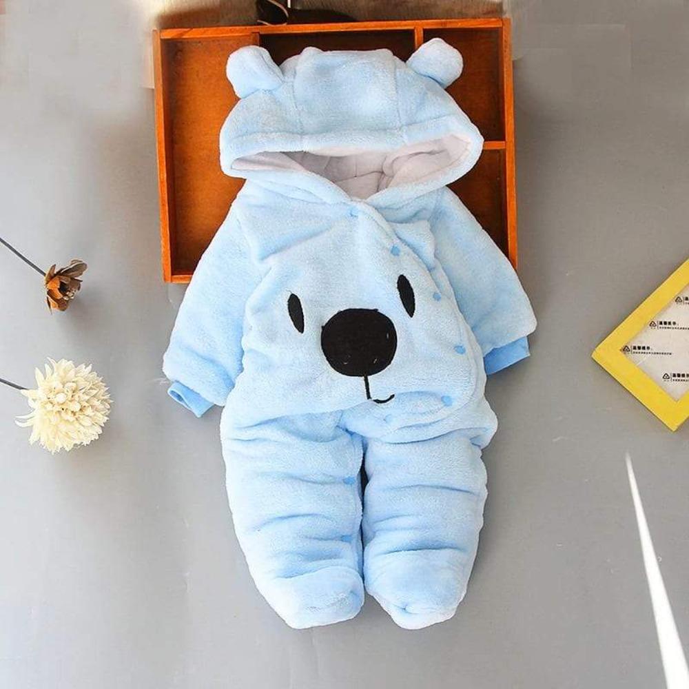 Close-up of soft fabric on unisex baby bear hoodie jumpsuit, comfortable infant apparel.