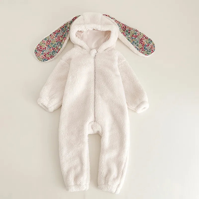 Baby crawling in a cozy grey rabbit hooded fleece romper, essential newborn outfit.