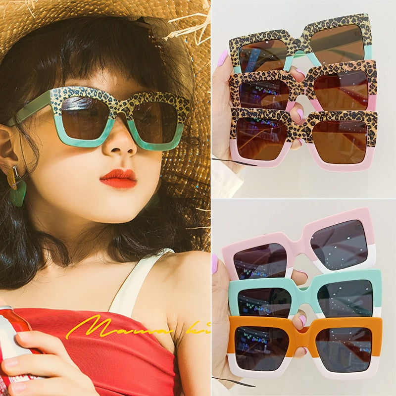 Adorable baby in leopard print sunglasses, offering stylish sun protection and a cute look for infants.
