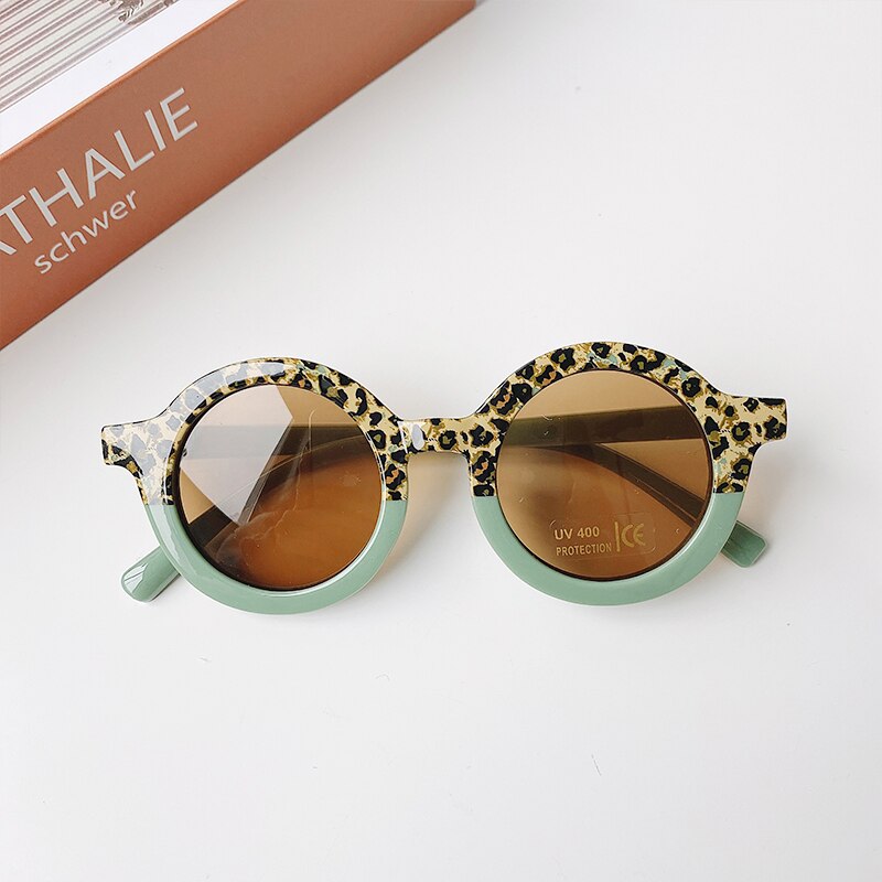 Side view of leopard print baby sunglasses, showing the frame shape and comfortable infant fit.