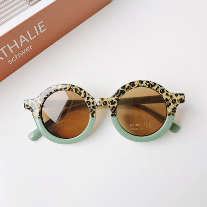 Side view of leopard print baby sunglasses, showing the frame shape and comfortable infant fit.