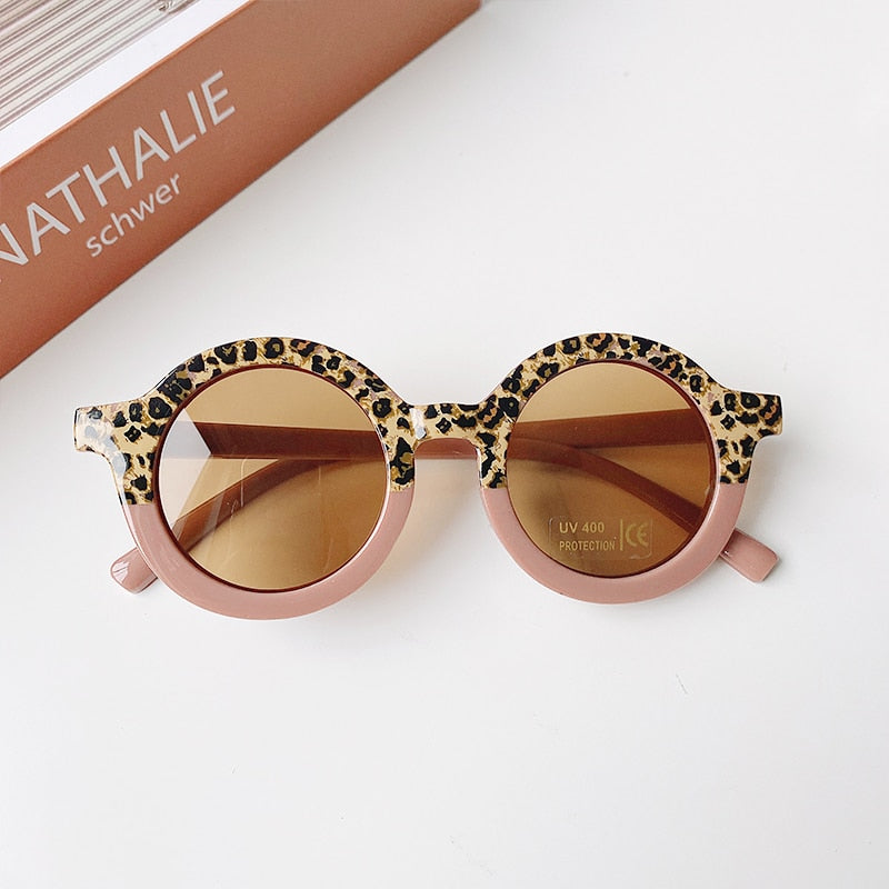 Stylish baby sunglasses with a leopard print frame, designed for infant eye protection and kid fashion.