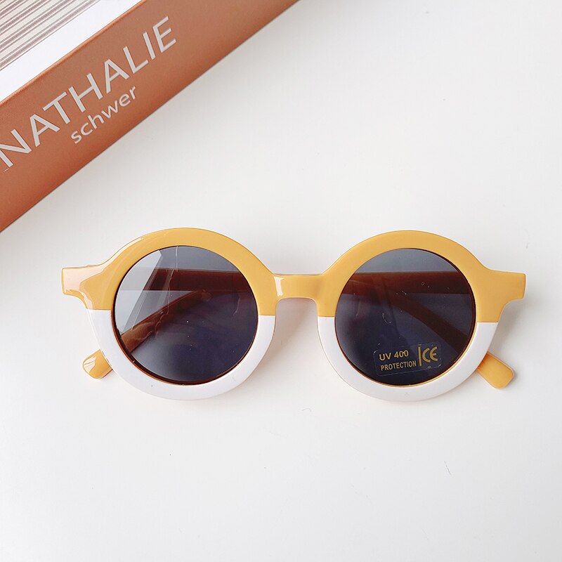 Cute baby wearing leopard print shades, ideal for sun protection and adding a fashionable touch.