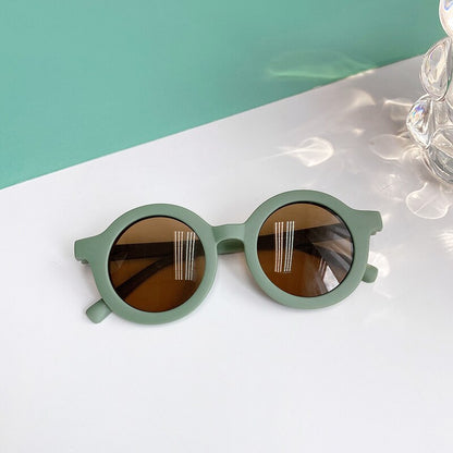Happy baby in leopard print sunglasses, ready for outdoor adventures and sun-safe play.