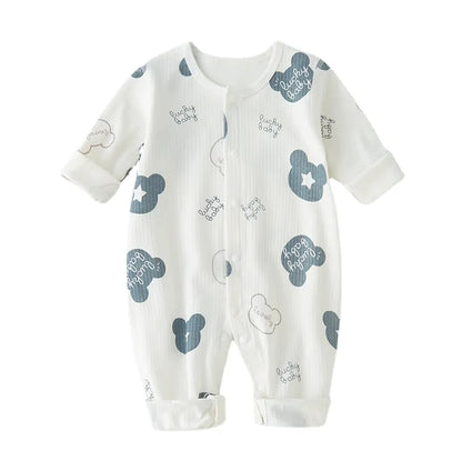 Adorable baby in soft white cotton newborn romper, perfect for boys and girls.