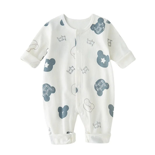Adorable baby in soft white cotton newborn romper, perfect for boys and girls.