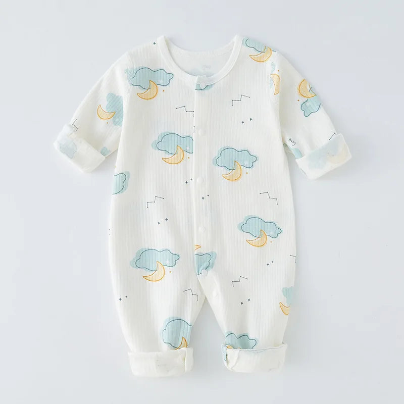 Baby girl smiling sweetly in a cozy, all-season cotton romper. Infant clothing.