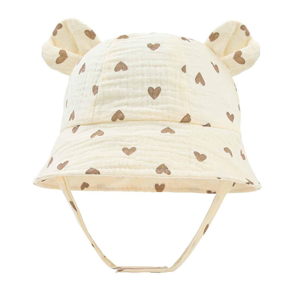 Pink cotton toddler sun hat, featuring an adjustable chin strap for a secure fit, sun safety