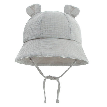 Smiling infant in a comfortable cotton fisherman sun hat, essential for outdoor toddler activities