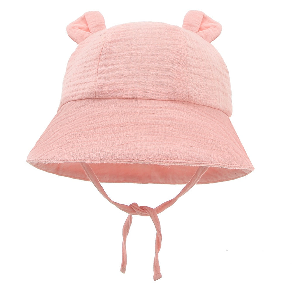 Cute infant in a striped cotton fisherman sun hat, a must-have baby accessory for warm weather