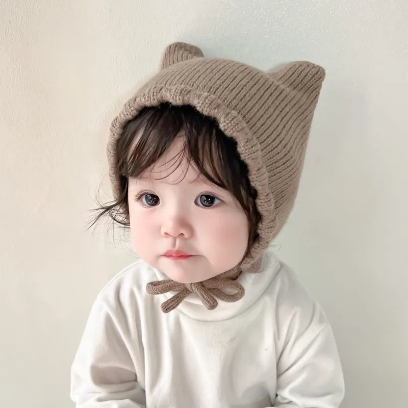 Adorable baby knit winter hat with ear protection and a cute cartoon animal design for infants