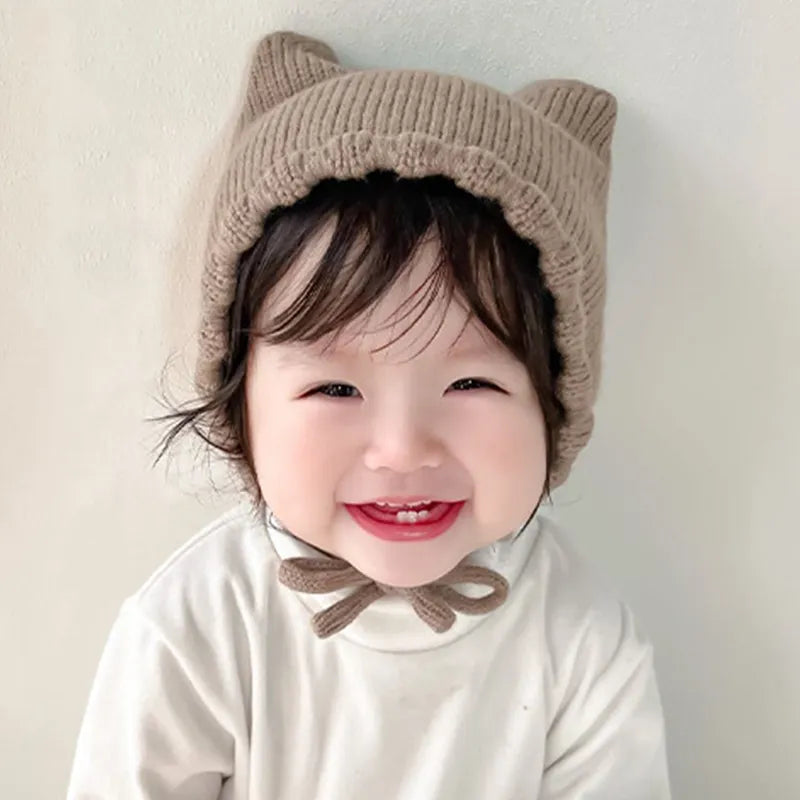 Baby knit winter hat, featuring a charming cartoon and practical ear protection