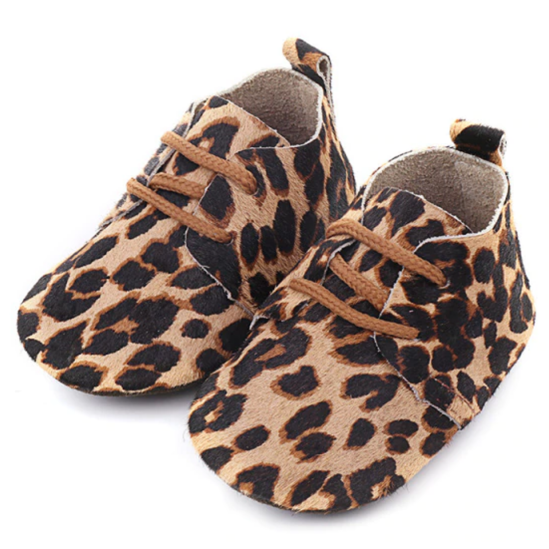 Close-up of a genuine leather baby moccasin, showcasing soft sole and anti-slip grip for first walkers.