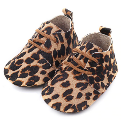 Close-up of a genuine leather baby moccasin, showcasing soft sole and anti-slip grip for first walkers.