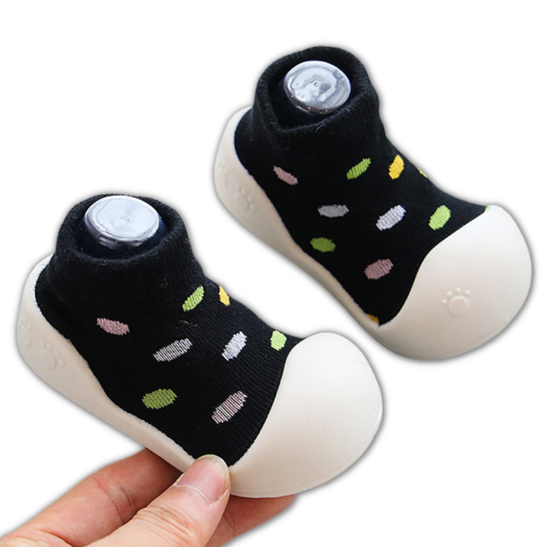Assortment of multicolor baby booties with soft, non-slip soles, perfect for growing infants.