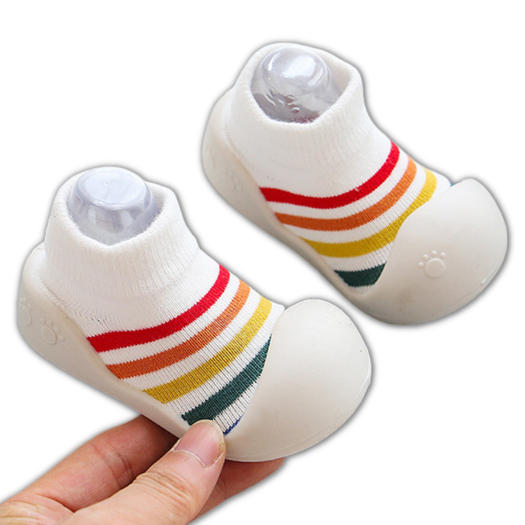 High-angle view of non-slip infant walker shoes, made from breathable multicolor cotton fabric.