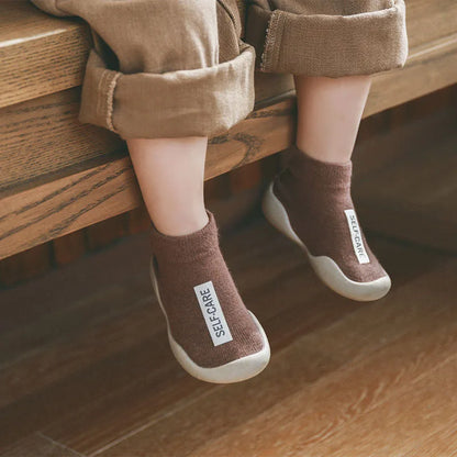 Close-up of a soft sole non-slip toddler walking shoe, showing knit texture and grip.