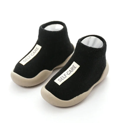 Baby's first walking shoes featuring a flexible soft sole and non-slip grip for safety.