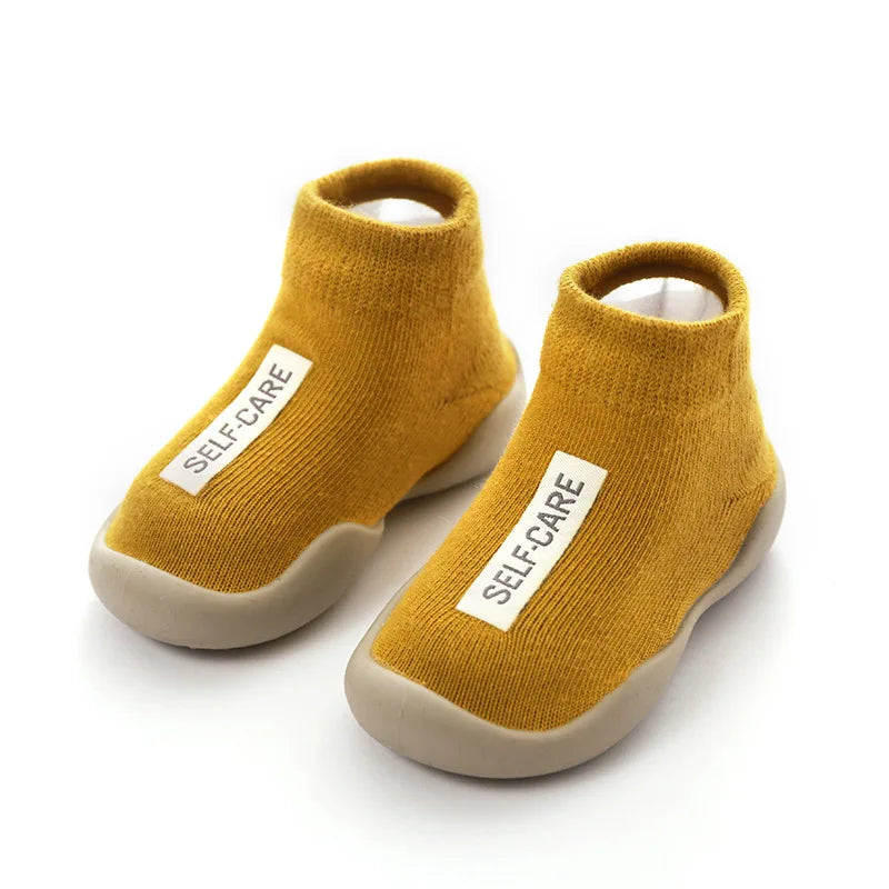 Lightweight baby walking shoes with a non-slip sole, designed for comfort and stability.