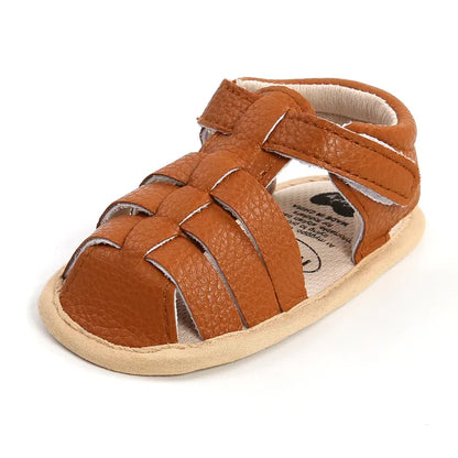 Outdoor shot of baby summer sandals on a grassy surface, ready for play.