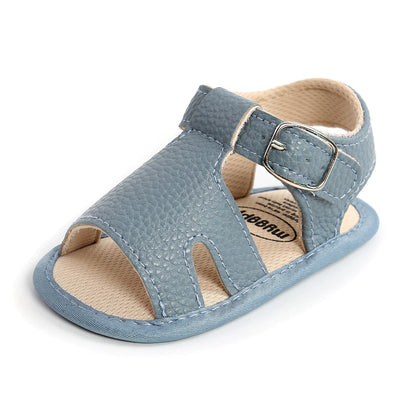 Happy child wearing comfortable soft grip toddler sandals in a park setting.
