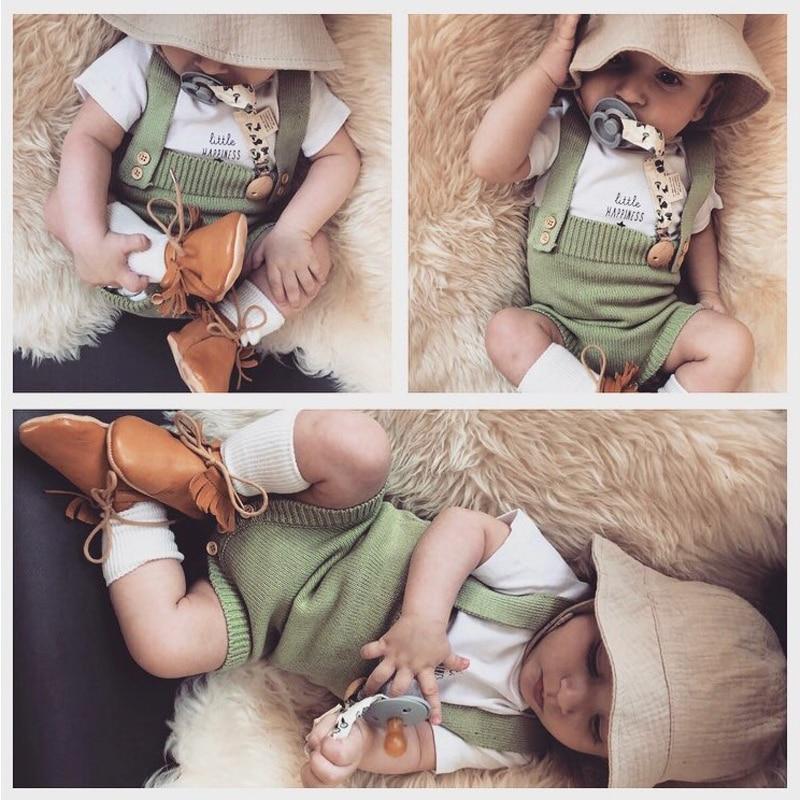 Adorable baby wearing a cozy hand-knitted warm wool romper, perfect for infants.