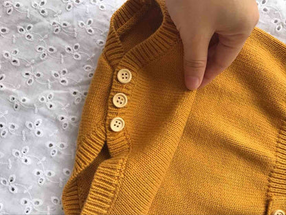 Baby romper made from natural wool, showcasing its cozy texture and quality knitwear.