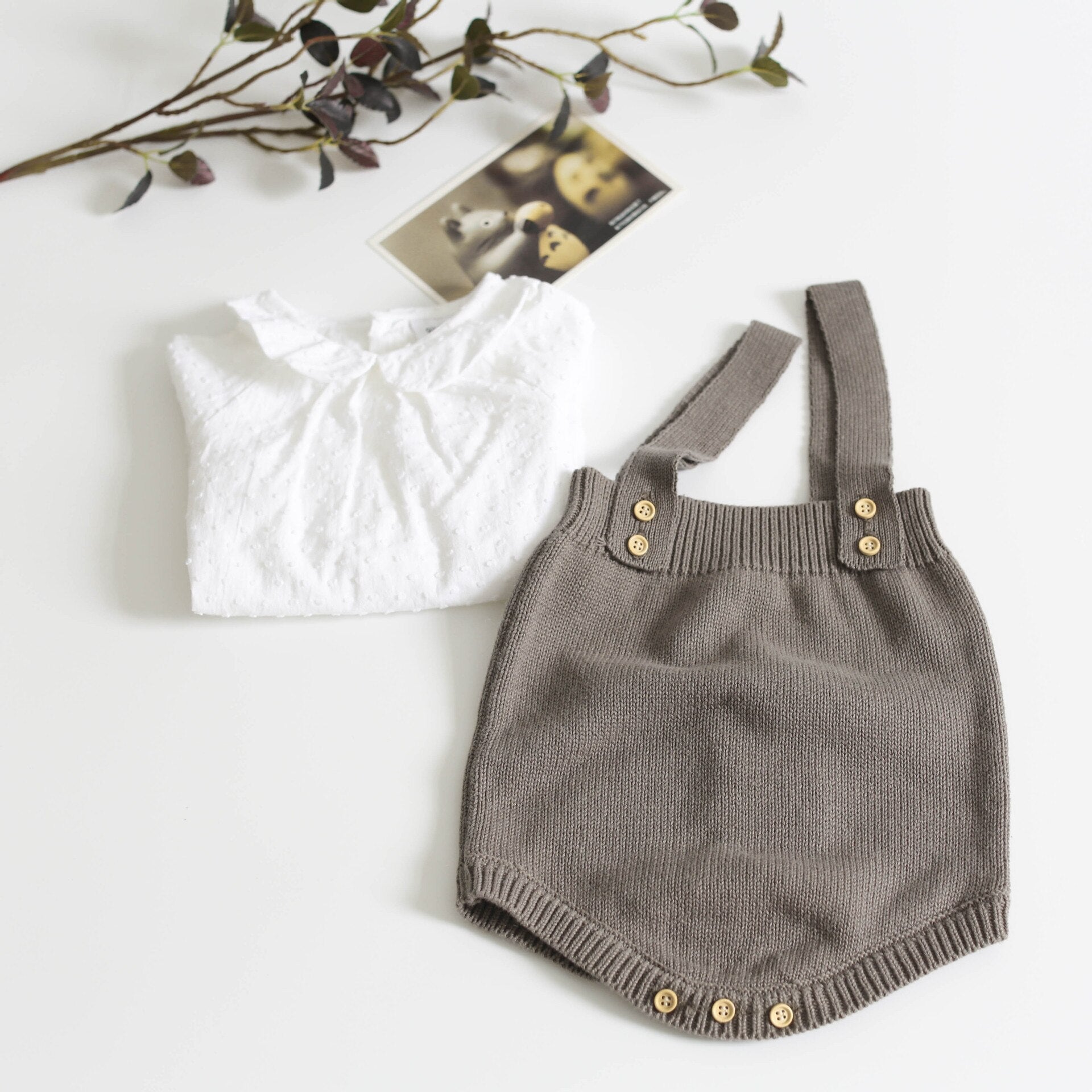 Sweet baby in a soft, hand-knitted warm wool romper, embodying cozy baby clothes.