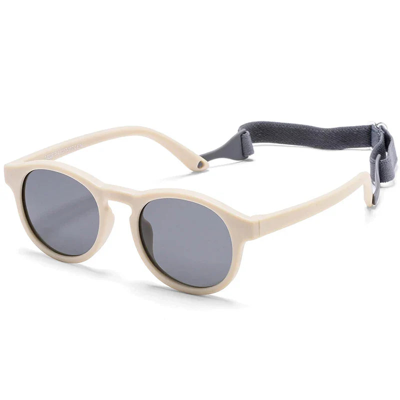 Adorable baby wearing pink polarized UV400 sunglasses, offering safe eye protection and style for infants.