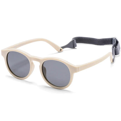 Adorable baby wearing pink polarized UV400 sunglasses, offering safe eye protection and style for infants.