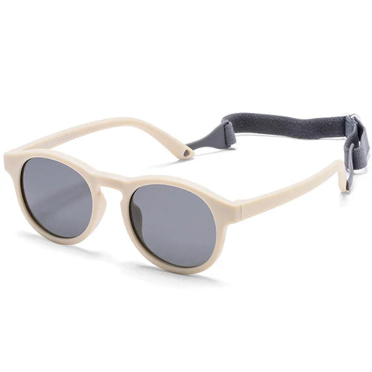 Adorable baby wearing pink polarized UV400 sunglasses, offering safe eye protection and style for infants.