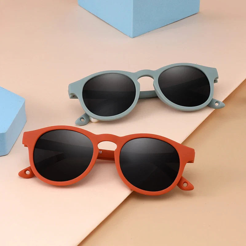 Close-up of blue baby polarized UV400 sunglasses with round TR-90 frame, ideal for infant eye protection.