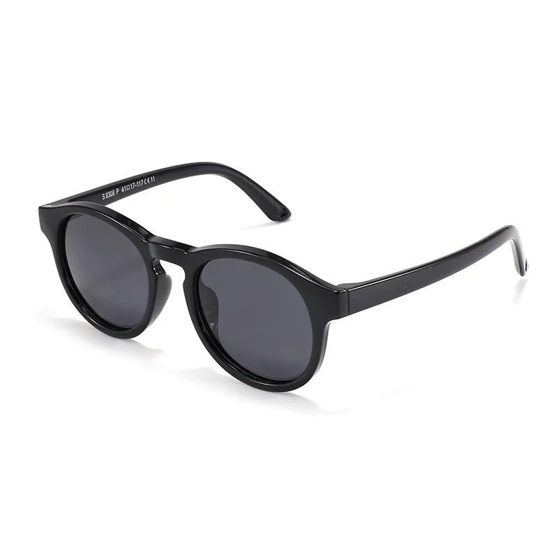 Group of colorful baby polarized UV400 sunglasses in pink, blue, yellow, and green on a white background.