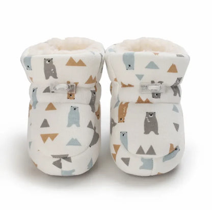 Soft-sole baby animal slippers, non-slip winter footwear, providing warmth and safety for toddlers.