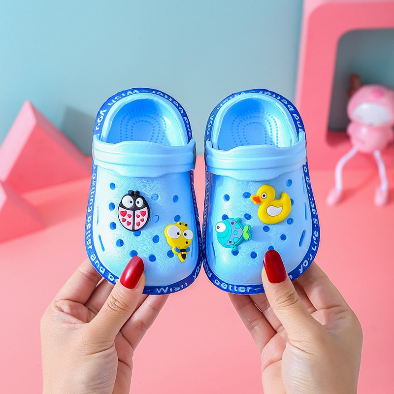 Overhead view of multiple pairs of kids cartoon EVA sandals, an array of colors for summer