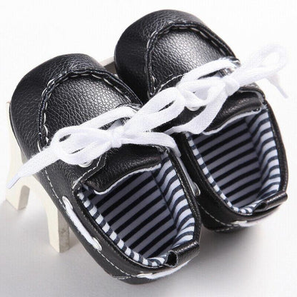 Close-up of a baby leather loafer boot, perfect for first walkers, with detailed stitching and soft sole