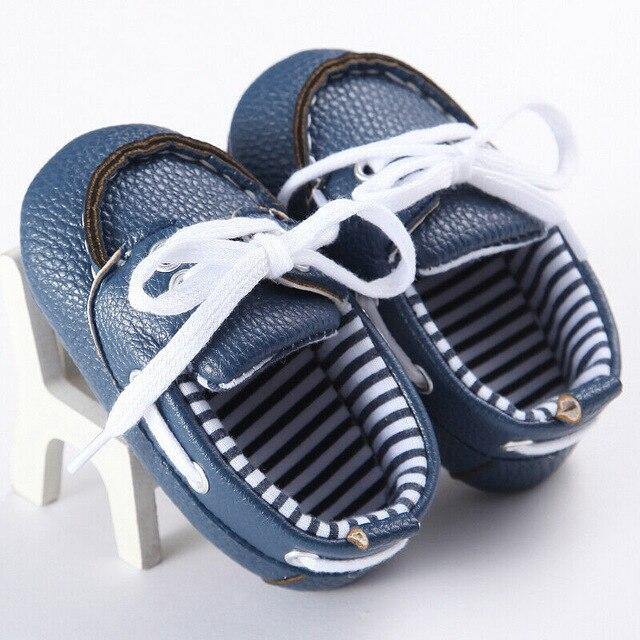 Pair of stylish baby leather loafer boots in a neutral color, suitable for first walkers, soft and safe toddler shoes